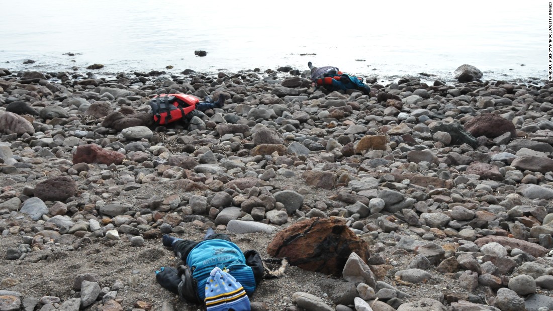 The bodies of migrants are seen on a beach after the boat capsized in the Aegean Sea. Authorities report that at least five children were among the dead. 