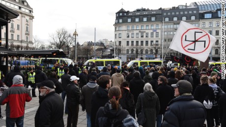 Protesters gather Saturday in Stockholm to show their disapproval of an anti-immigrant group&#39;s actions.