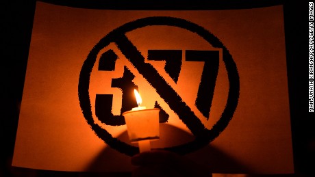 An Indian LGBT activist holds a placard during a demonstration against the Supreme Court's reinstatement of Section 377, in Bangalore on January 28, 2014. 