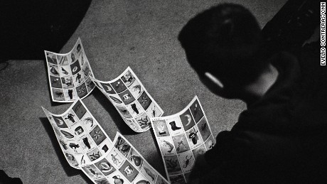 Jesús searches for the lucky cards in his family&#39;s Lotería game.