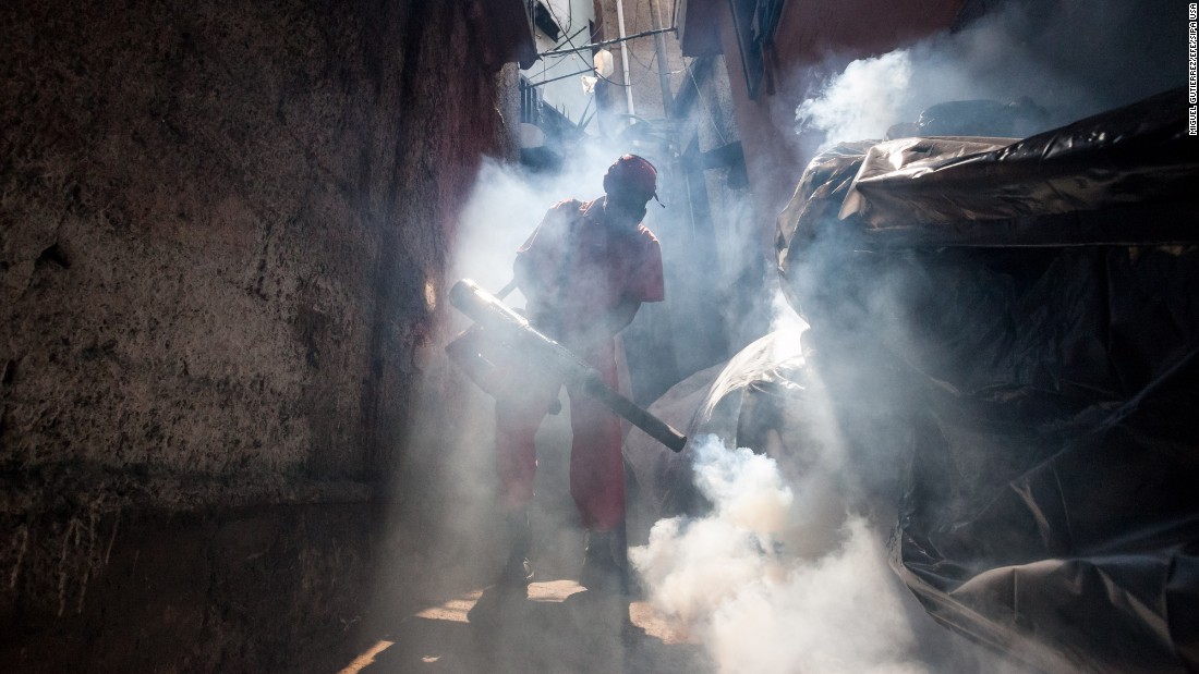 A health worker fumigates an area in Caracas, Venezuela, on Tuesday, February 2. 