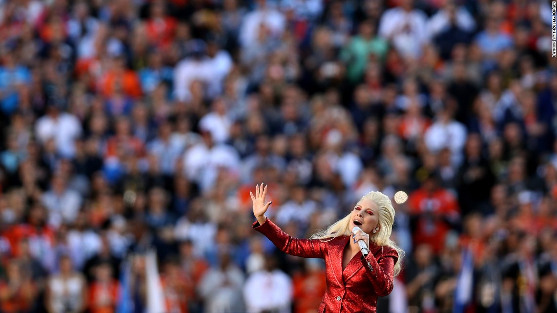 Lady Gaga performs the national anthem before the start of the game.
