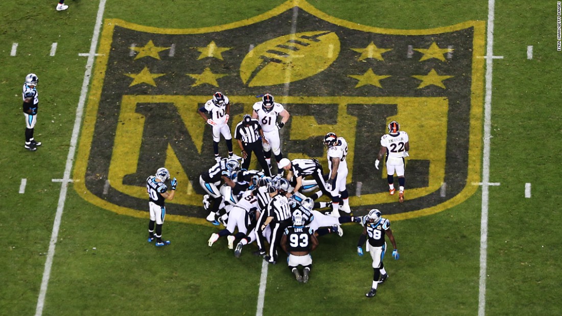 Denver and Carolina players attempt to recover a Manning fumble in the fourth quarter.