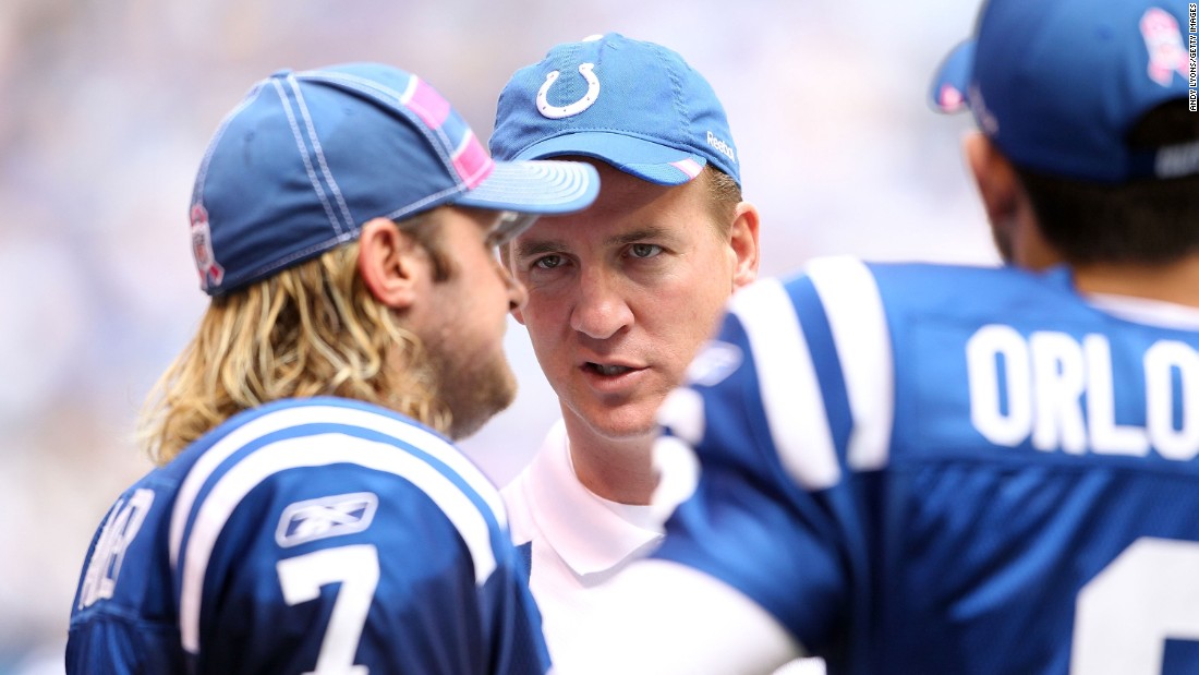 Manning talks to Colts teammate Curtis Painter during a game in 2011. Manning missed the entire season after undergoing surgery for a herniated disc in his neck.
