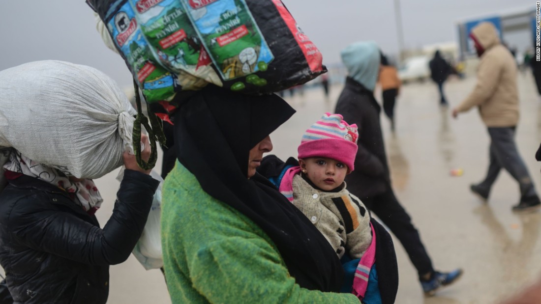 Refugees arrive near the Turkish border as they flee the city of Aleppo on February 6.