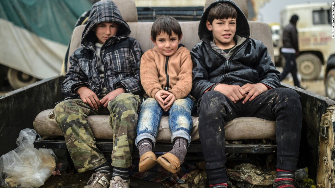 Refugee children sit on a car near the Turkish border crossing on February 6.