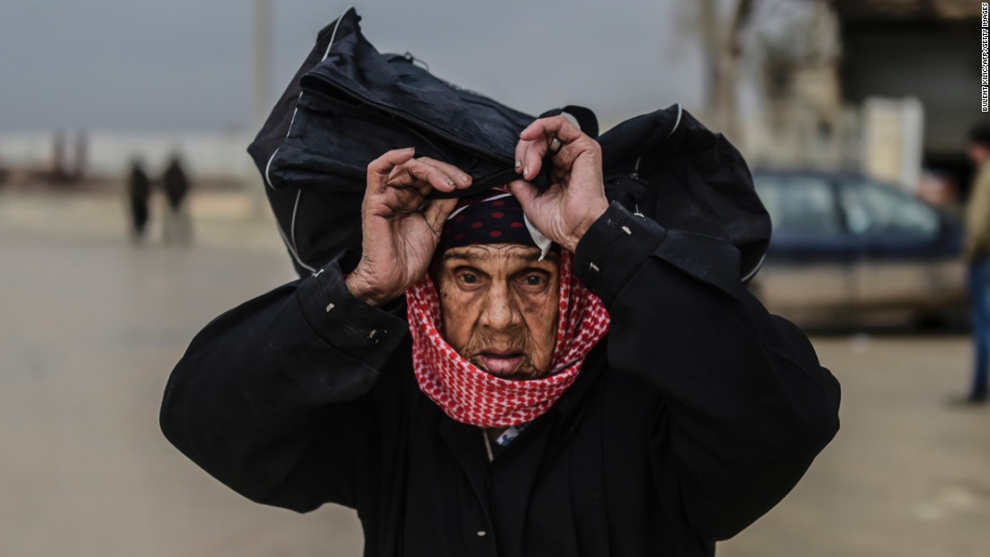 A refugee woman carries her belongings near the Turkish border gate on February 6.