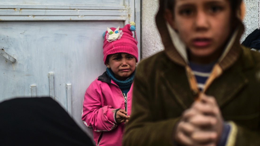 A refugee girl reacts near the Turkish border gate on February 6.