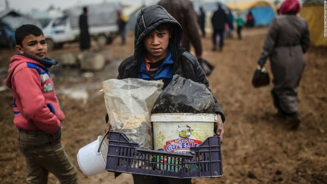 A child carries his belongings as Syrian refugees arrive at the Turkish border on February 6.