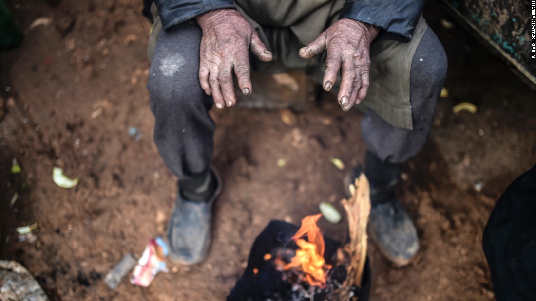A refugee warms himself at a bonfire near the Turkish border on February 6.