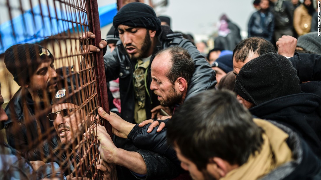 Refugees jostle one another for tents near the Turkish border on February 6.