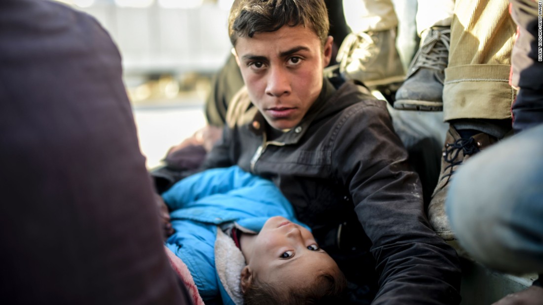 A Syrian teenager and a child look on near the Turkish border on February 5.