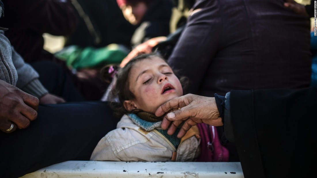 A child sleeps as Syrians fleeing the northern embattled city of Aleppo wait near the Turkish border on February 5, 2016.