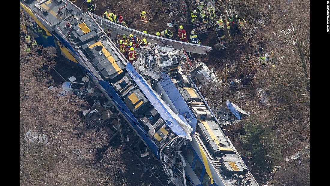 Rescue workers search the site of a deadly train accident near Bad Aibling, Germany, on Tuesday, February 9. Two trains collided in the southern state of Bavaria, police said.