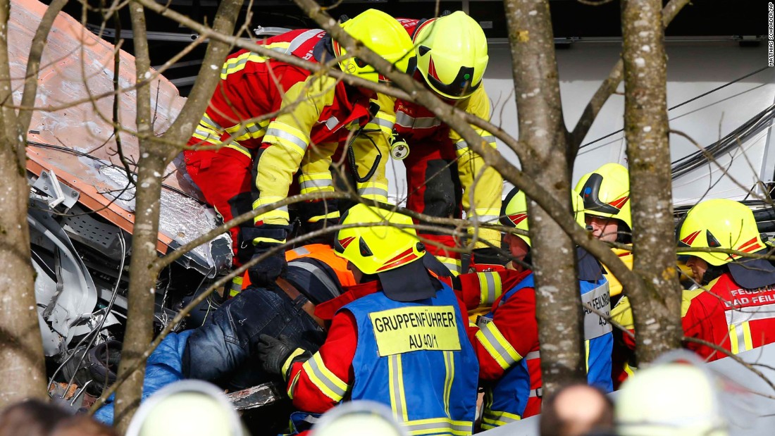 Rescue workers salvage a body at the site of the crash.