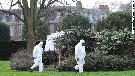 Forensics officers study the scene near where a man set himself on fire Tuesday outside Kensington Palace.