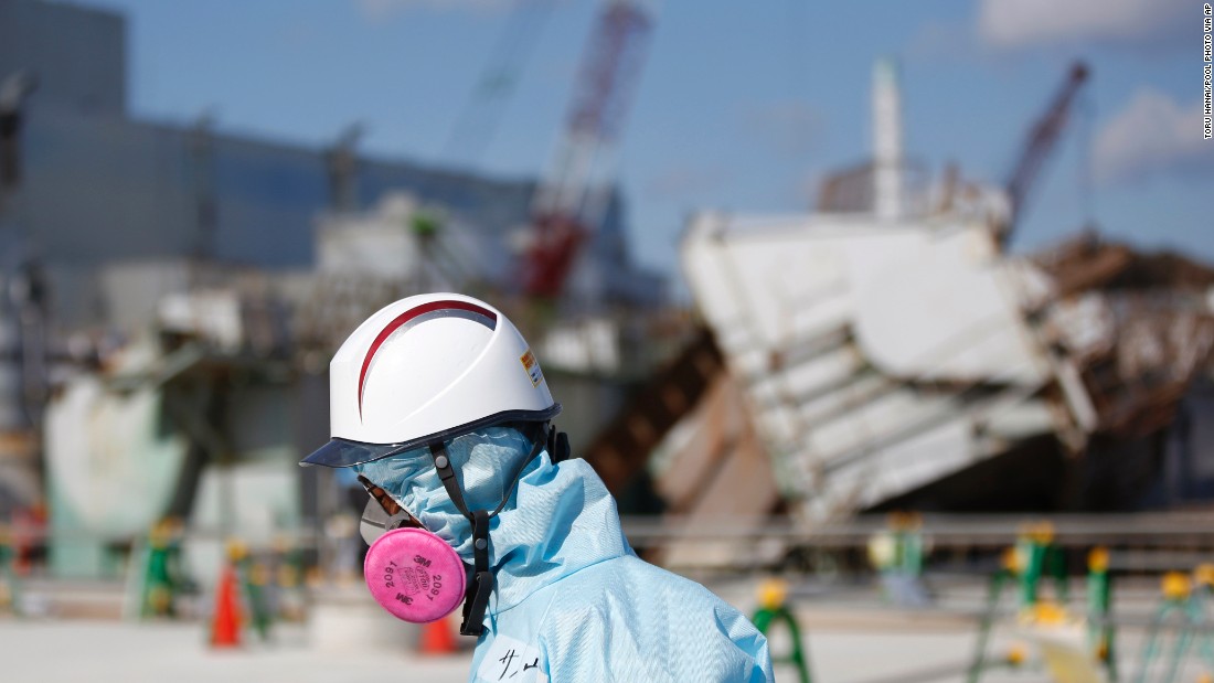 A TEPCO employee walks past the No. 1 reactor at the Fukushima Daiichi nuclear plant on February 10, 2016. Next month, Japan will mark the fifth anniversary of the Fukushima disaster, when an earthquake and tsunami hit on March 11, 2011, leaving more than 15,000 people dead.