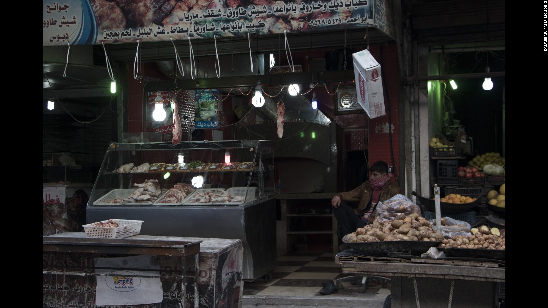 A stall holder waits for customers; there are reports of some hoarding of rice and flour as the regime&#39;s siege tightens.