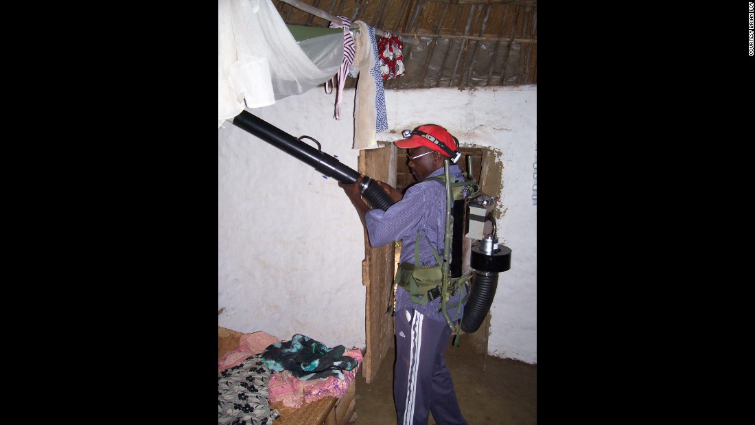 Research assistant Alassane aspirates mosquitoes inside a villager&#39;s home. After feeding on humans during the night, the mosquitoes often hide in bedding and along ceiling rafters. 