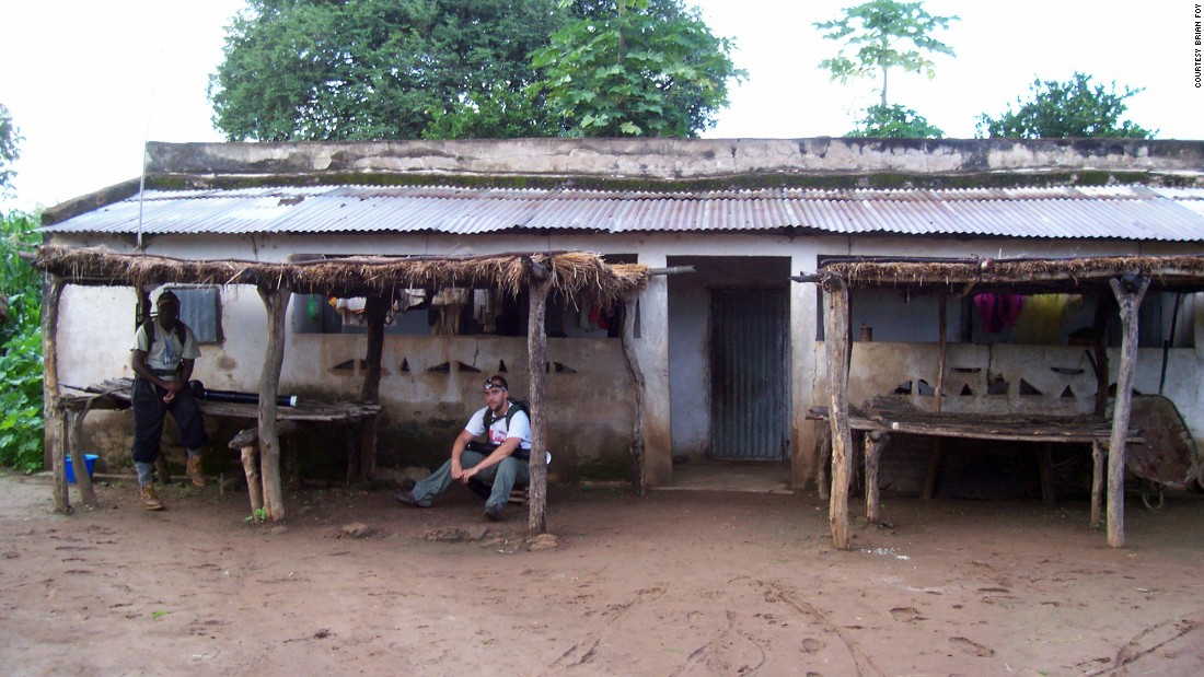 African researcher Massamba Sylla, left, and graduate student Kevin Kobylinski visit a villager&#39;s home in Ibel, Senegal. 