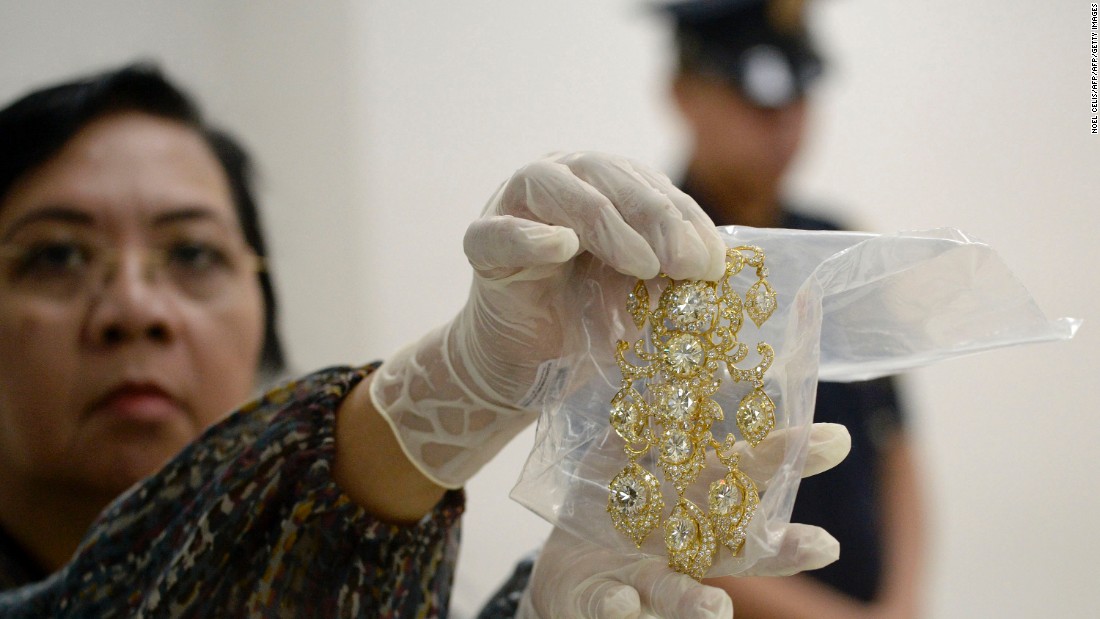 An agency official displays a diamond-studded piece of jewelery from the collection. Imelda Marcos was renowned for her lavish spending during her husband&#39;s time in power.