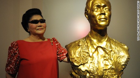 This photo taken on May 5, 2013 shows Philippine former first lady Imelda Marcos standing next to a bust of her late husband and Philippine president Ferdinand Marcos in Batac town, Ilocos Norte province, north of Manila. 