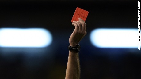 A referee shows a red card during a Copa Sudamericana match in Argentina in 2014.