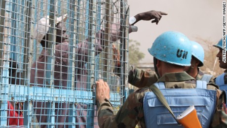 A South Sudanese civilian speaks with UN peacekeepers at the United Nations base in the northeastern town of Malakal as clashes continued there Thursday.
