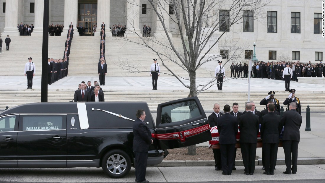 The pallbearers unload Scalia&#39;s casket from a hearse.