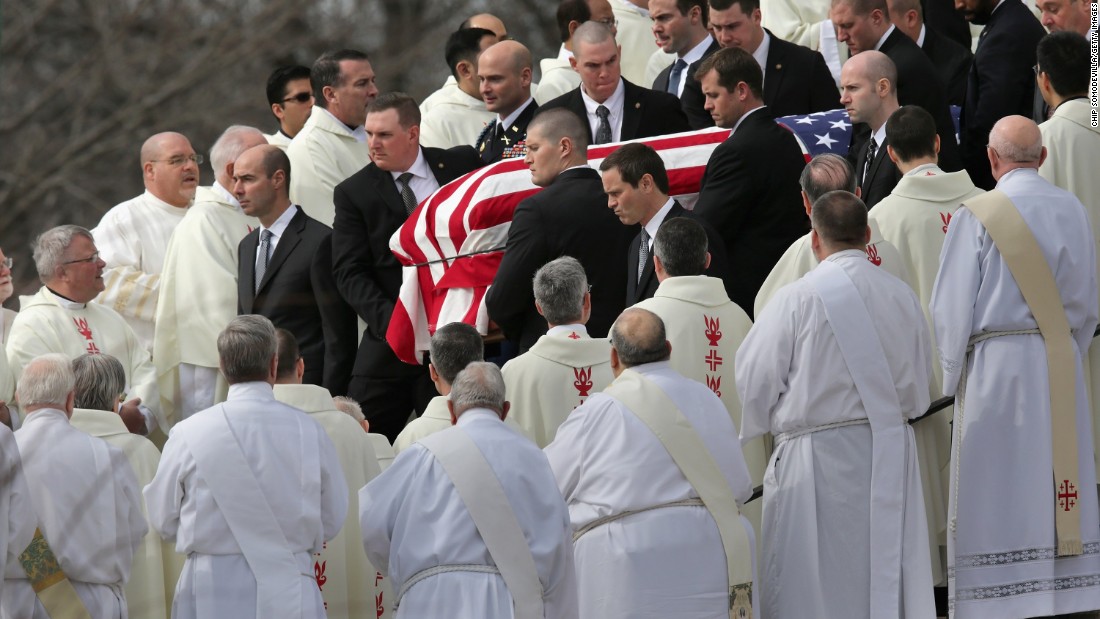 U.S. Supreme Court Police pallbearers carry Associate Justice Antonin Scalia&#39;s flag-covered casket between rows of Catholic clergy and out of the Basilica of the National Shrine of the Immaculate Conception after his funeral on Saturday, February 20, in Washington.