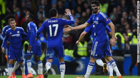 The masked Diego Costa celebrates with teammate Pedro after scoring the opener in Chelsea&#39;s 5-1 win over Manchester City in the FA Cup. 