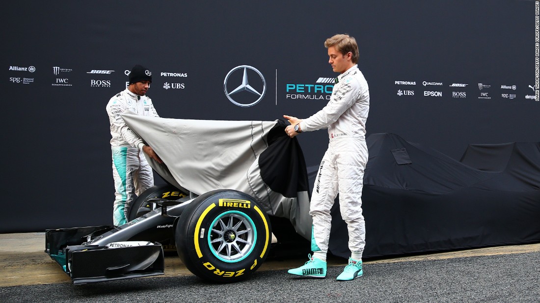 Uncovered! After winning back-to-back team titles, Lewis Hamilton (back) and teammate Nico Rosberg (front) take the covers off the new Mercedes Formula One car.