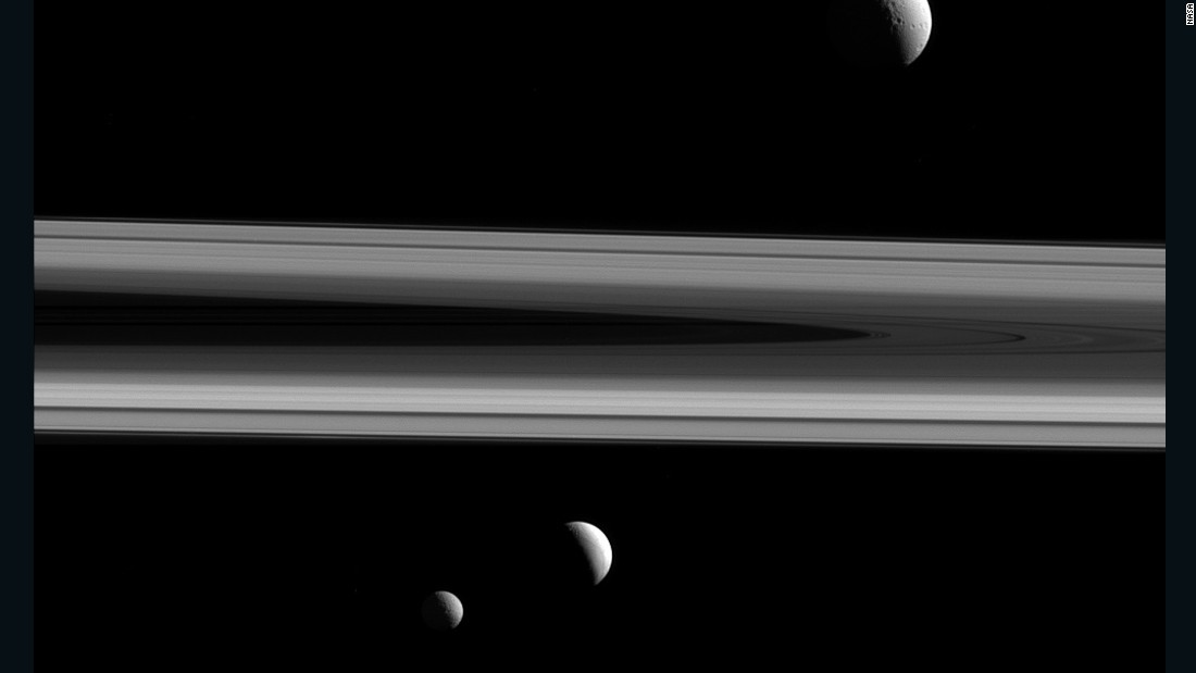 Saturn&#39;s moons Tethys, Enceladus and Mimas are shown in this image taken by the Cassini spacecraft on December 3, 2015. Tethys is above the rings, Enceladus is below the rings in the center of the image, and Mimas is below and to the left. Cassini has been exploring Saturn and its moons since 2004. The mission is scheduled to end in September 2017.