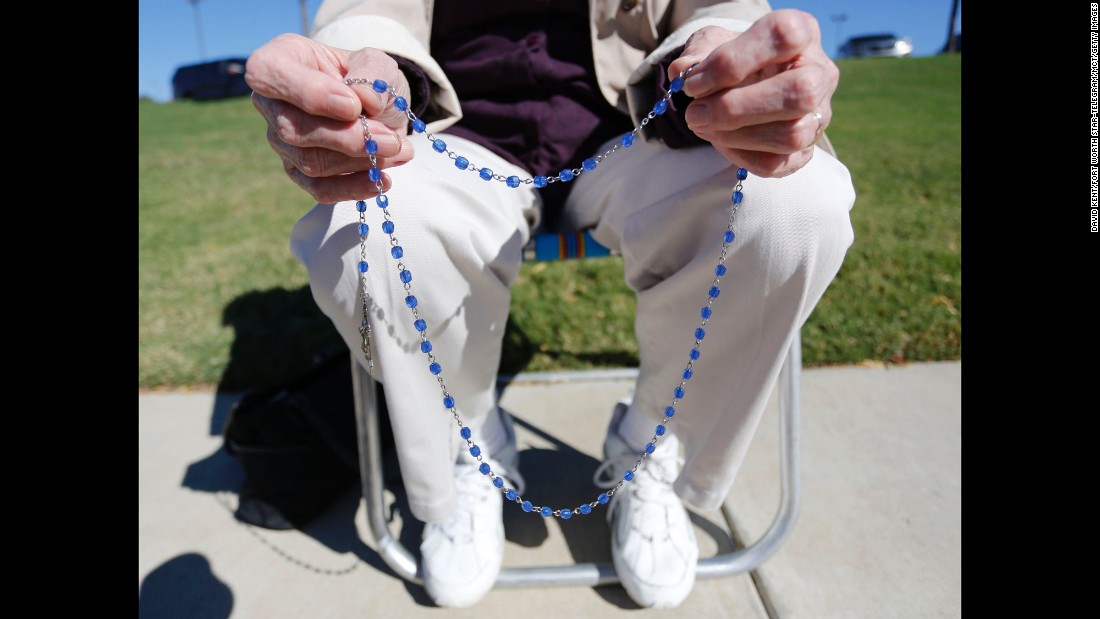 Three days later, on October 31, 2013, the U.S. 5th Circuit Court of Appeals reversed the federal district judge&#39;s decision. Here, a woman holds her rosary beads as she prays on the sidewalk across the street from Planned Parenthood in Fort Worth, Texas.