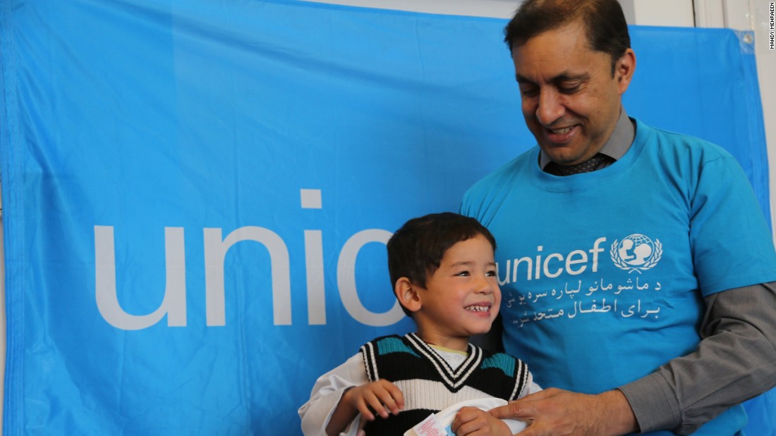 UNICEF Afghanistan representative Akhil Iyer presents the thrilled Murtaza with his gifts from Messi, the Argentine star who plays for Barcelona.