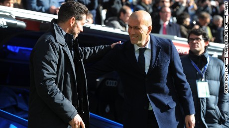 Real Madrid manager, Zinedine Zidane (R), welcomes Atletico Madrid coach, Diego Simeone to the Santiago Bernabeu.