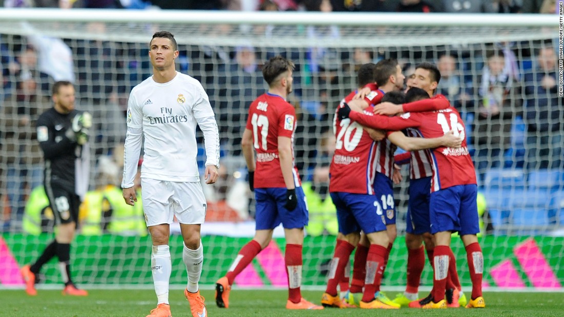 Atletico players celebrate on full time as Ronaldo walks away in frustration.