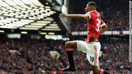 High flyer: Marcus Rashford celebrates scoring the opening goal for Manchester United at Old Trafford.