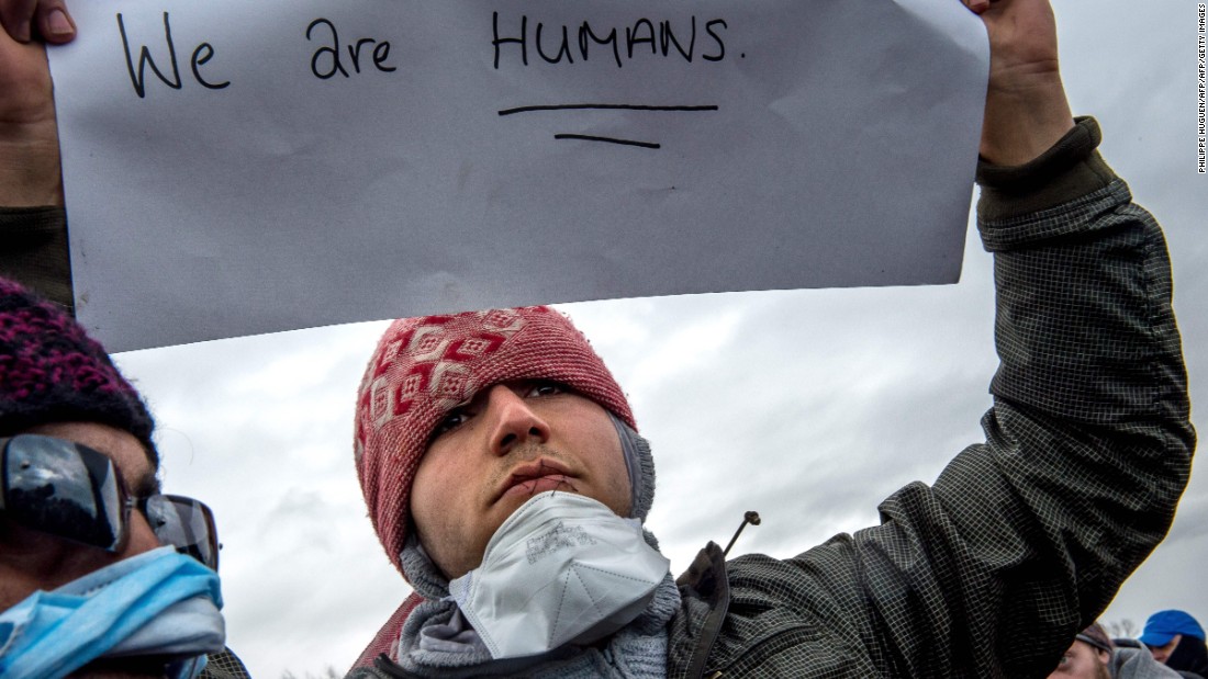 The migrants held signs saying &quot;We are humans&quot; and &quot;Where is your democracy?&quot; during a protest in the camp on Wednesday, March 2.