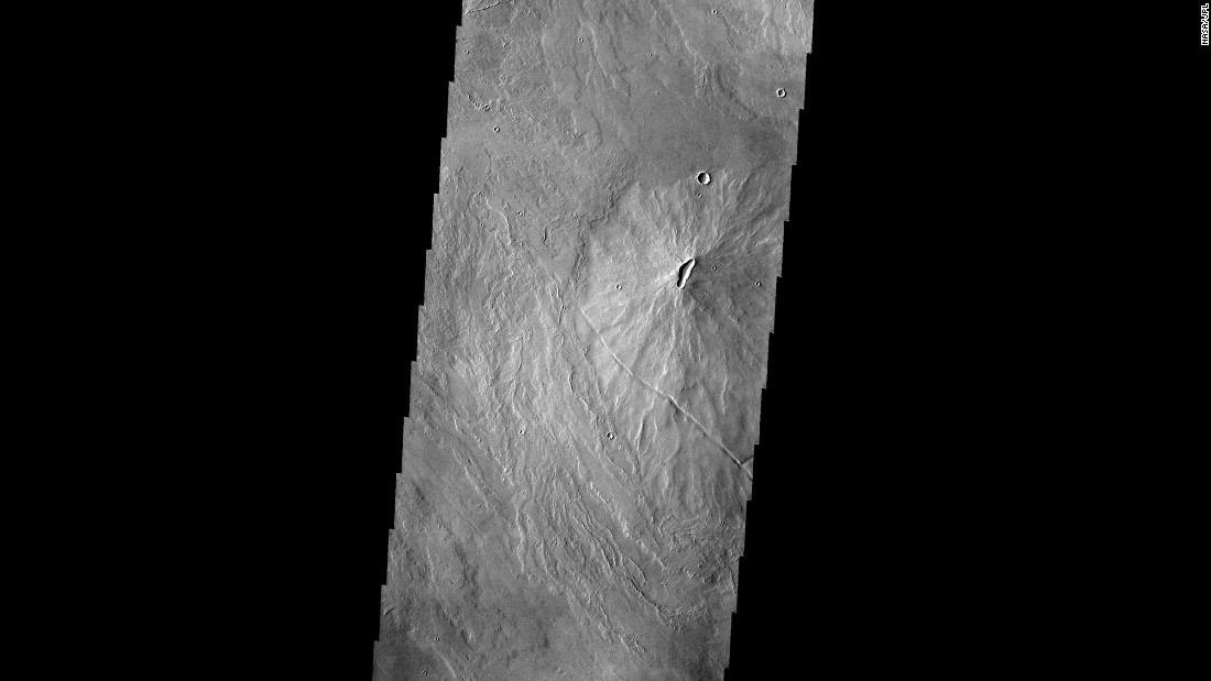 This image taken by the Mars Odyssey spacecraft shows volcanoes dotting the Martian landscape in the Tharsis region.