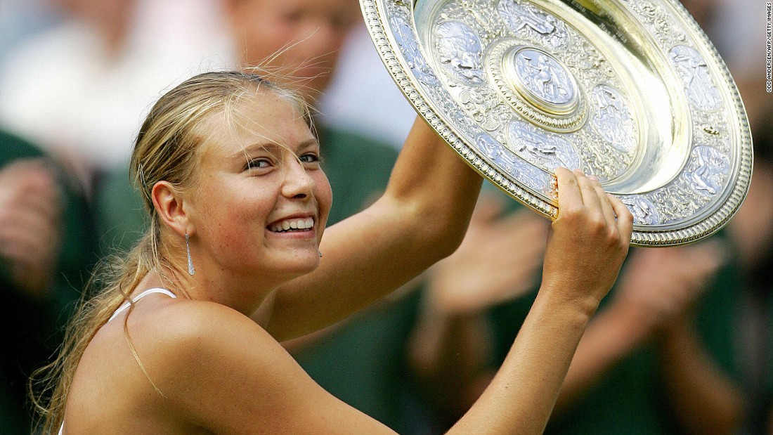 Sharapova holds up her trophy after she won Wimbledon in July 2004. The 17-year-old defeated Serena Williams in the final for her first Grand Slam title.