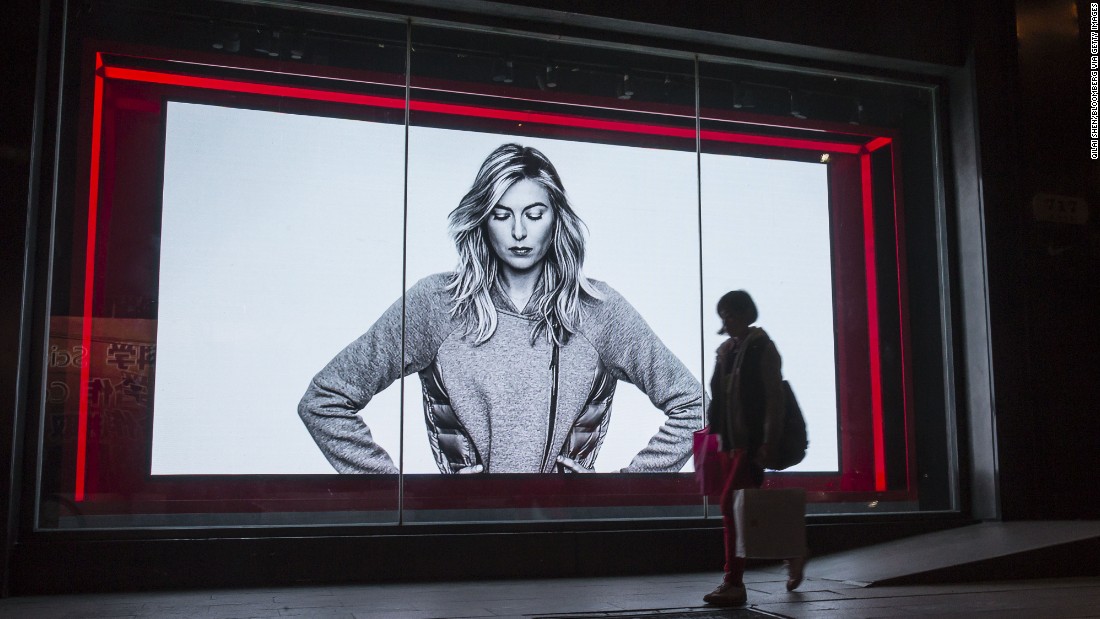 A shopper in Shanghai, China, walks past a Nike advertisement featuring Sharapova.