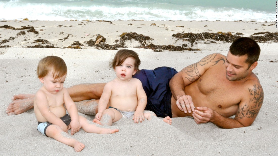 Ricky Martin poses with his sons Valentino and Matteo in Miami. The bilingual singer is raising his twin boys to speak Spanish, English and French.