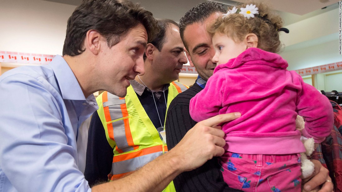 Trudeau greets Syrian refugees Kevork Jamkossian and daughter Madeleine during their arrival at Toronto&#39;s Pearson International Airport in December 2015. The new Prime Minister pledged to take in and resettle 25,000 Syrian refugees in Canada.