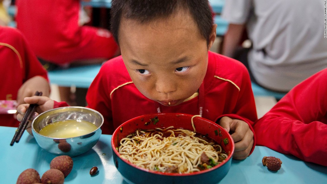 A young player eats in the school&#39;s canteen. Special chefs have been flown in from the northwestern Xinjiang province to cater for the dietary requirements of the region&#39;s Muslim players.