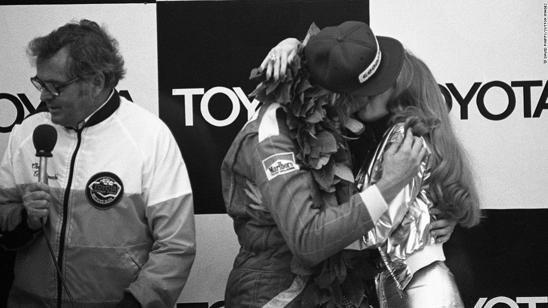 Hunt celebrates his win at 1977 United States Grand Prix with a Penthouse Pet on the podium.