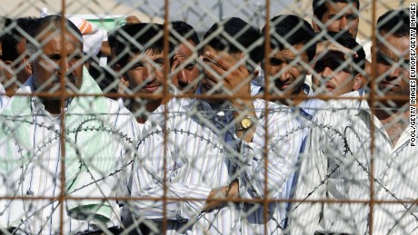 Detainees stand in the Abu Ghraib prison yard while waiting to be released on June 27, 2006, in Baghdad, Iraq.