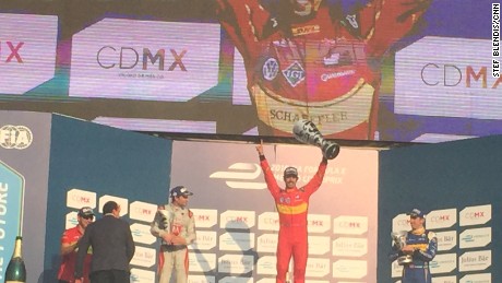 Lucas di Grassi (center) celebrates on the podium following Formula E&#39;s first ever race in Mexico.