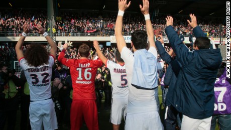 Paris Saint-Germain&#39;s team celebrates with its supporters after clinching its fourth straight Ligue 1 title and sixth overall.