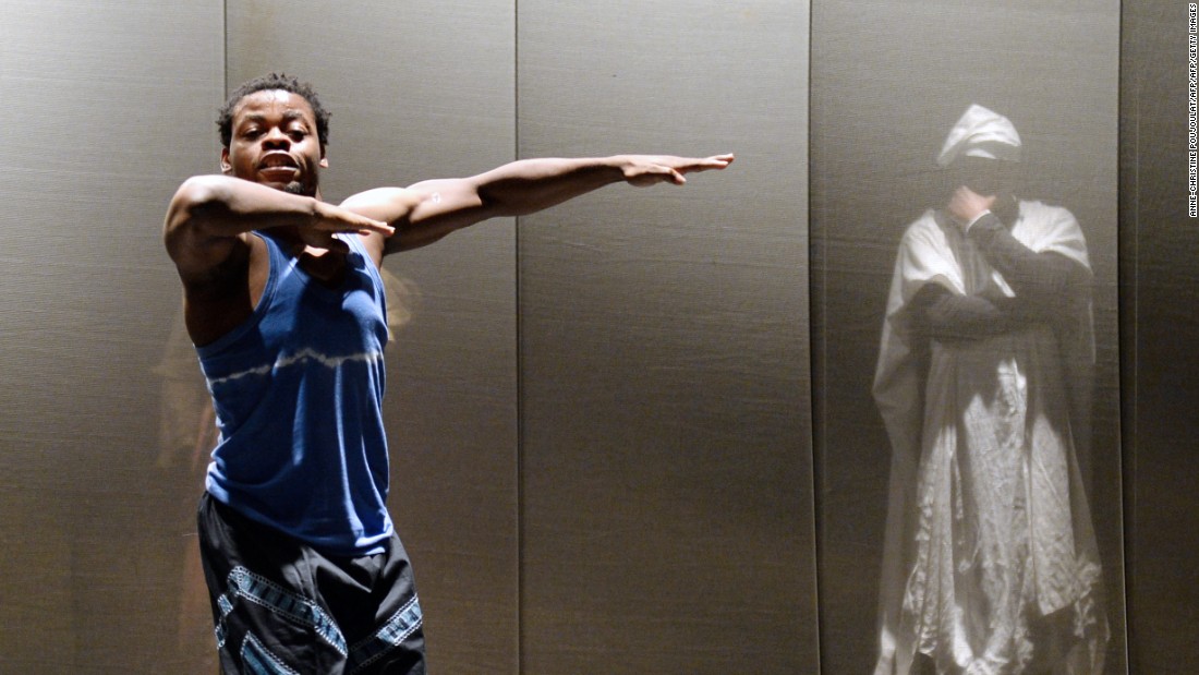 Nigerian dancer and choreographer Qudus Onikeku (left) and Cameroonian actor Emil Abossolo perform a scene of Onikeku&#39;s creation &quot;Qaddish&quot; at the Salle Benoit XII in Avignon, as part of the 67th international theater festival.    